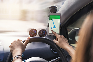 woman using gps navigation map on smartphone in car woman using gps navigation map on smartphone in car